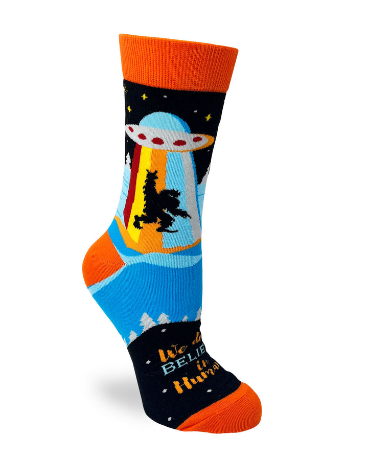 We Don't Believe in Humans Novelty Crew Socks with yeti, spaceship, and dinosaur .